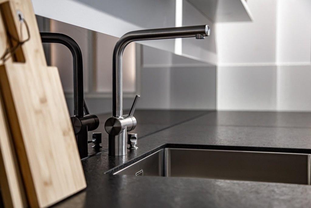 new-modern-steel-faucet-kitchen-room-sink-close-up.jpg