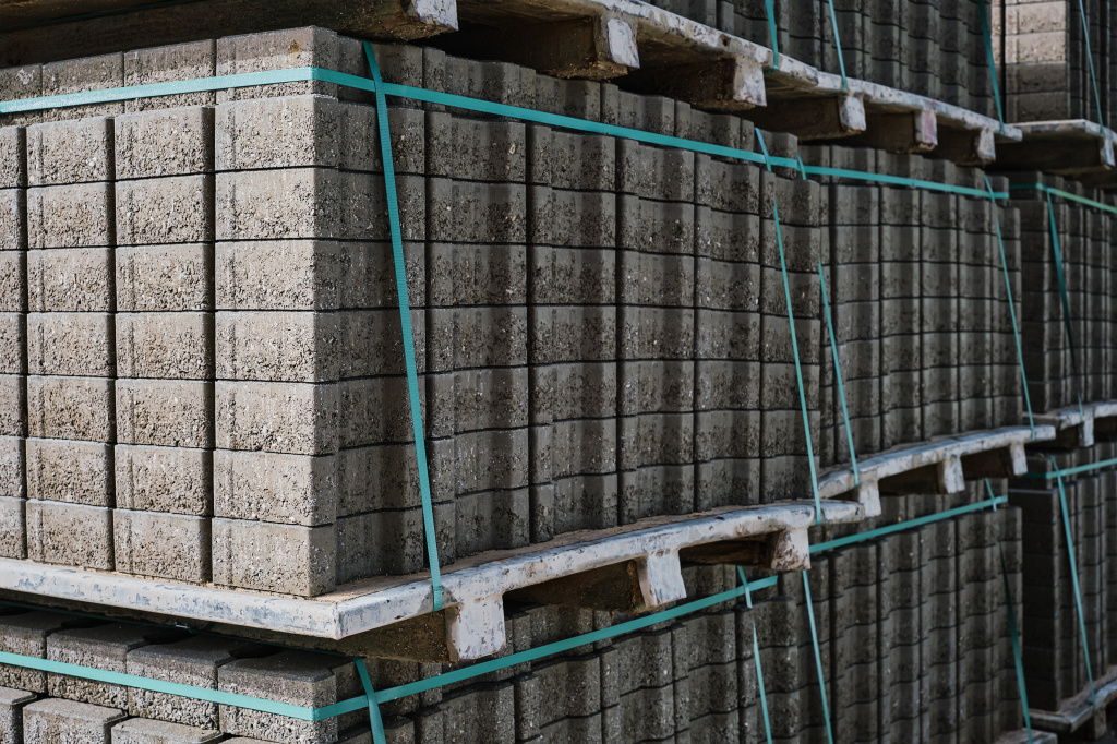 pallets-with-stacked-gray-paving-slabs-selective-focus-stack-paving-slabs-warehouse-road-repair-finished-tile-sale-space-text.jpg